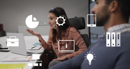 Image of business icons over diverse colleagues discussing work