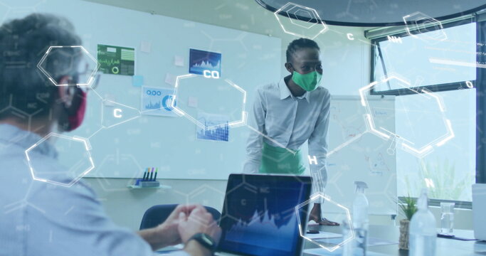 Image of chemical formula over diverse colleagues at meeting with face masks