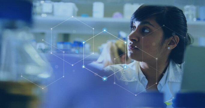 Image of scientific data processing over biracial female scientist in laboratory