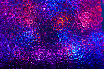Glass texture in blue and red tones. Colorful Bubbles with Gradient Texture .circle wallpaper .Dark round pattern background with flashes of light. 