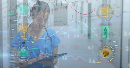 Image of scanners and charts processing medical data over biracial female doctor writing notes