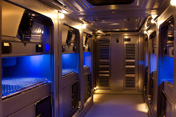 Fototapeta premium futuristic spacecraft corridor, ambient blue lighting, sleek metal surfaces