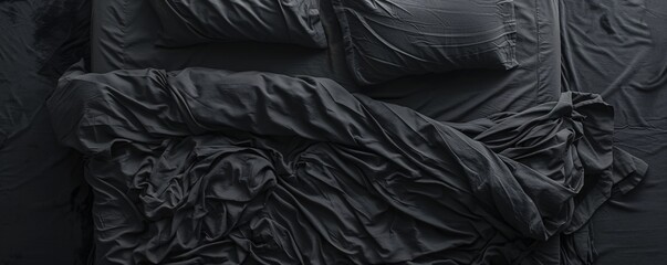 Fototapeta premium Abstract pattern created by unmade bed with dark gray sheets