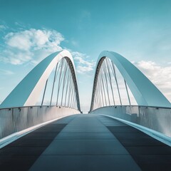 Obraz premium An impressive arch bridge set against a backdrop of a vivid blue sky with fluffy clouds, capturing both architectural elegance and nature's beauty harmoniously.