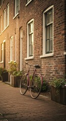 Fototapeta premium Vintage bicycle by brick wall in sunlit urban street