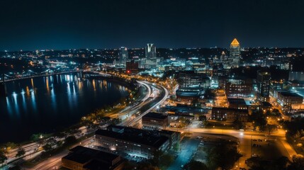 18.A stunning nighttime view of Cincinnati’s downtown district, with a vibrant skyline illuminated by city lights. The towering buildings and sleek skyscrapers reflect the glow of streetlights and