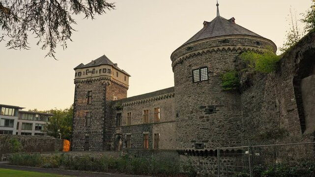 Medieval tower and fortress wall during a summer sunrise with parallax movement, Andernach, Rhine River Valley, Germany