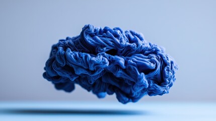 A floating, textured blue form against a light background, resembling abstract art.