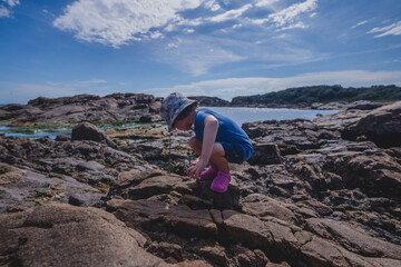 Boy exploring rock pools