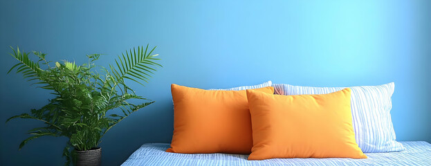 Orange pillows, plant, blue wall, bedroom