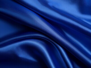 Obraz premium A luxurious deep blue silk satin fabric with elegant, soft wavy folds. The fabric has a liquid wave effect, reflecting light beautifully. A rich navy blue tone dominates the scene