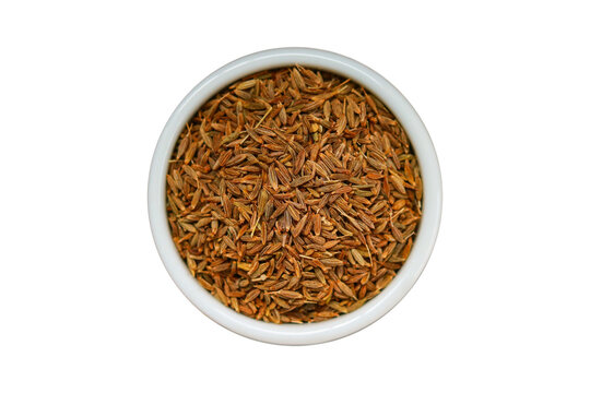 Dried cumin seeds in a bowl isolated on a transparent background.