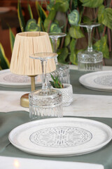 Elegant table setting with decorative plates and greenery