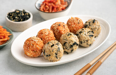 Korean Rice Balls (Jumeokbap) with kimchi and seaweed, selective focus