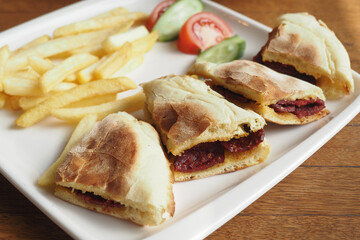 Tasty sandwiches with crispy fries and fresh veggies