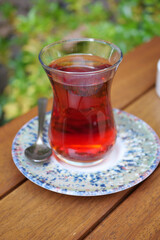 Freshly turkish tea served in a glass on a wooden table