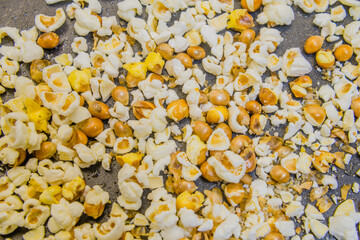 Close-up of popcorn with unpopped kernels scattered across the surface