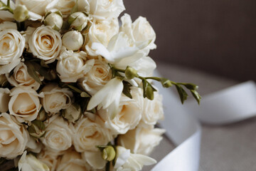 A wedding bouquet of white roses with baby's breath. Wedding preparation, background with copy...