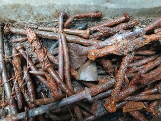 Fototapeta premium Close up of rusty nails as background with grunge texture of corroded metal. Rust. Nails. Metallic. rusted metal objects. Construction material. Many rusted nails, Group of Iron rust, Metal surface.