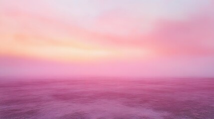 Fototapeta premium A large, empty field under a pastel-colored sky at dusk