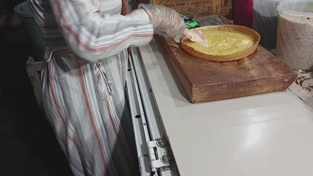 Asian Indonesian woman's hands cooking terang bulan street food with chocolate, A popular sweet pancake street food in Indonesia.