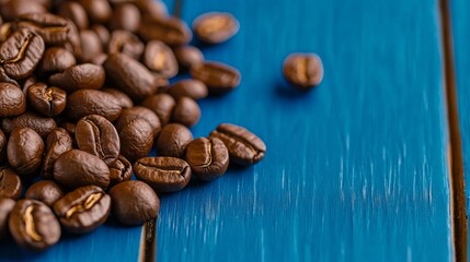 Naklejka premium Coffee beans close-up rustic blue surface food photography natural setting aesthetic view coffee culture