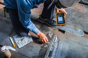 UT, Ultrasonic testing to detect imperfection or defect in welding of steel plate structure in factory. NDT Inspection.