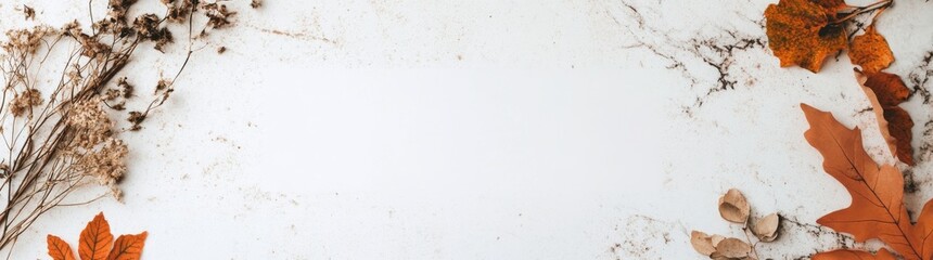 Autumn flat lay composition featuring a blank frame and vibrant orange leaves arranged on a marble surface