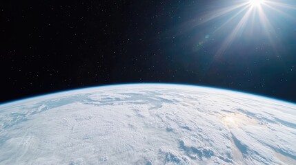 Fototapeta premium Planet Earth with a curved horizon and thick white cloud cover is illuminated by the bright sun shining in the dark void of outer space.