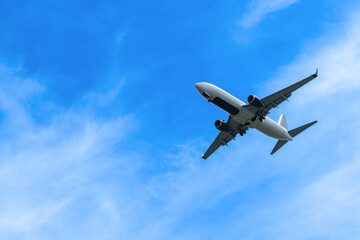Airplane flying in the sky preparing to land at the airport. Air travel and traveling abroad
