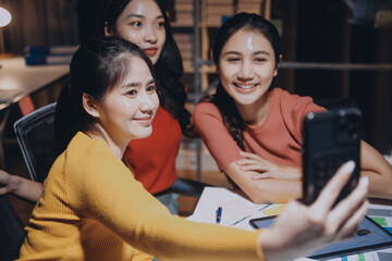 Business people working late at laptop in highrise office