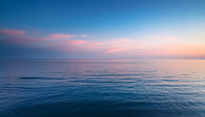 Calm ocean beneath pastel skies.
