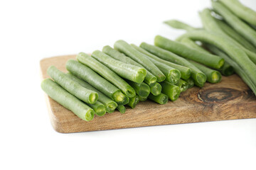 Freshly Cut Green Beans on a Wooden Board Isolated on White Background