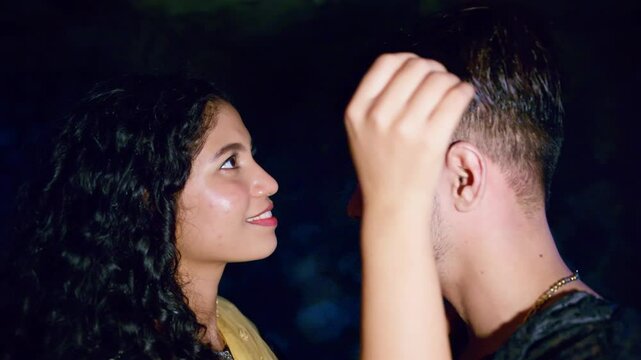 Couple playfully holding each other by dark