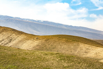 Fototapeta premium Mountains and blue sky with passing clouds.