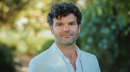 Man smiles, garden background, portrait, professional headshot