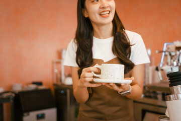 A beautiful young woman barista smiling warmly while making fresh coffee in a cozy café, creating a welcoming atmosphere and serving customers with skill and charm in a modern coffee shop