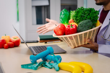 A male nutritionist sitting at a table, advising on healthy diets, promoting vegetable-based meals,...