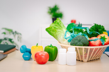 A nutritionist's table with a vegetable basket, fruits, pill bottles, and a dumbbell, symbolizing health, balanced nutrition, fitness, supplements, and a commitment to a healthy lifestyle