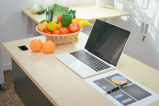 A desk with a fruit basket symbolizes a nutritionist's workspace, promoting healthy eating, balanced diets,wellness through the presentation of fresh fruits organized tools for nutritional planning