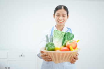 A cute female nutritionist doctor holds a basket of vegetables and fruits against a white background, symbolizing healthy eating, balanced diets, wellness,promoting nutritious food choices overall