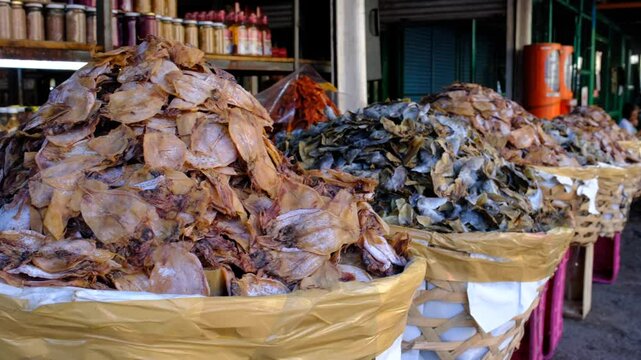 Close-up of different type of dried fish stacks at Carbon Market, Philippines, showcasing local seafood trade, traditional food preservation, and cultural market scenes.