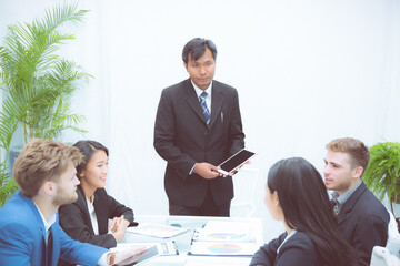 Fototapeta premium Group of team young business and executive discussing for planning marketing and strategy of financial at the office, manager and employee meeting for seminar about finance, at the conference room.