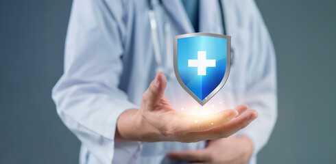 Medical shield floating above physician shows healthcare protection concept. doctor in white coat...