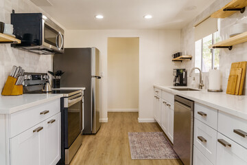 Modern Kitchen Interior with Stainless Steel Appliances and White Cabinets