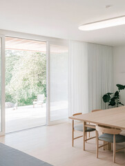 Fototapeta premium Minimalist dining area with large windows overlooking a serene outdoor space