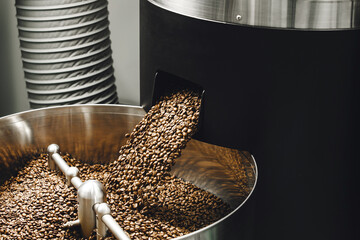 Freshly Roasted Coffee Beans Pouring Into Stainless Steel Cooling Bin