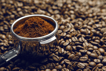 Freshly Ground Coffee in Espresso Holder Surrounded by Coffee Beans, Close up
