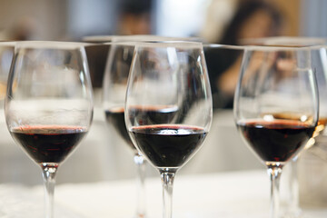 Close-up Photo of Various wine Glasses with Untitled Poured Wines Covered by Degustation Cards. Professional Wine Tasting Setup at Sommelier School.