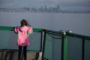 Young Girl on Washington State Ferry with Seattle Skyline in the Distance